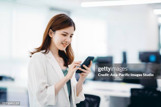 professional asian businesswoman using mobile phone in office. - cultura da ásia oriental imagens e fotografias de stock