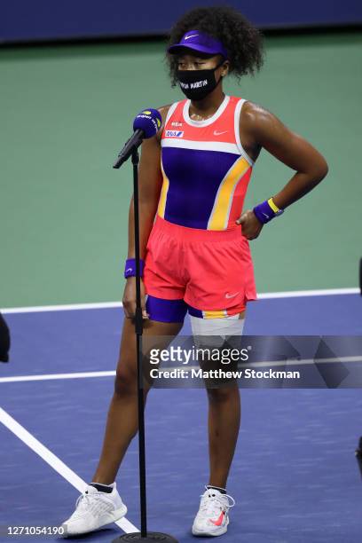 Naomi Osaka of Japan talks in a post match interview wearing a mask with the name of Trayvon Martin printed on it after her Women’s Singles fourth...
