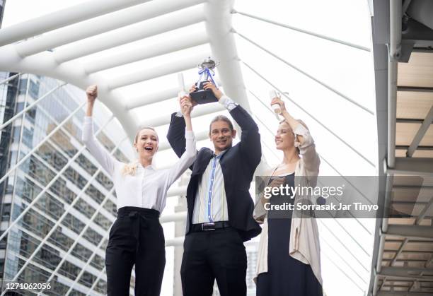 business people celebrating with team after hitting the target of business point - business awards ceremony stock pictures, royalty-free photos & images