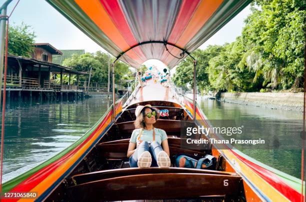 woman photographing with camera on river - longtail boat stock pictures, royalty-free photos & images