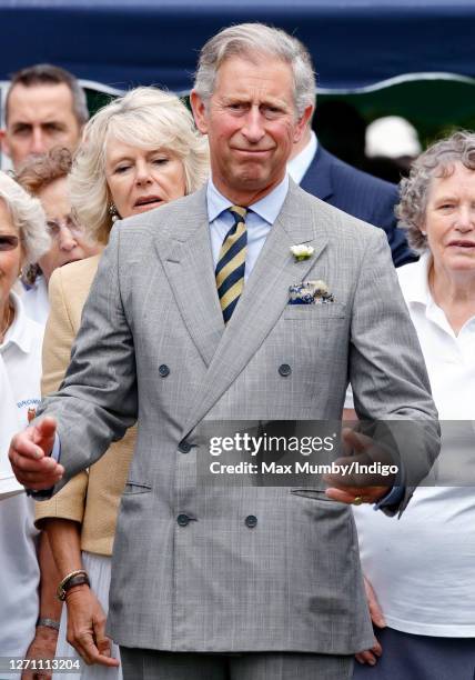 Camilla, Duchess of Cornwall looks on as Prince Charles, Prince of Wales plays bowls during a visit to the Wiltshire village of Bromham on July 17,...