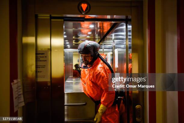 Health worker wears a protective suit and gloves as he moves the body of a deceased COVID-19 patient in a metal coffin at the ICU of Krakow...