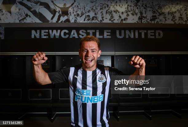 New signing Ryan Fraser poses for photographs wearing a home kit in the dressing room at St.James' Park on September 07, 2020 in Newcastle upon Tyne,...
