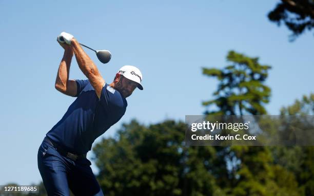 Dustin Johnson of the United States plays his shot from the fourth tee during the final round of the TOUR Championship at East Lake Golf Club on...