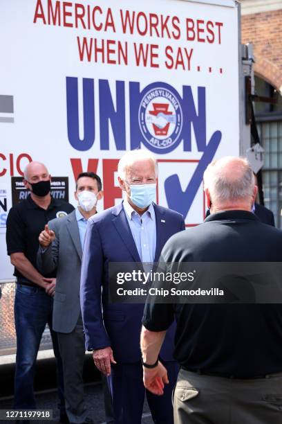 Democratic presidential candidate Joe Biden briefly visits with local labor leaders following a group photo at the state's AFL-CIO headquarters on...