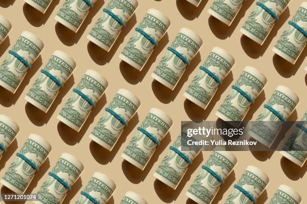 roll of american dollars banknotes on the beige background - one dollar bill stock pictures, royalty-free photos & images