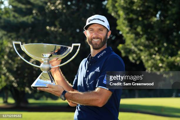 Dustin Johnson of the United States celebrates with the FedEx Cup Trophy after winning in the final round of the TOUR Championship at East Lake Golf...