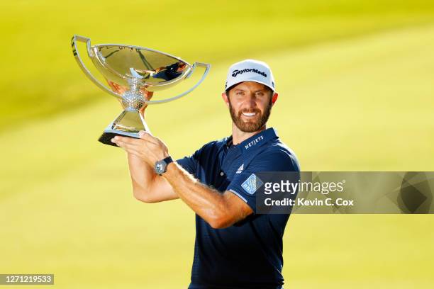 Dustin Johnson of the United States celebrates with the FedEx Cup Trophy after winning in the final round of the TOUR Championship at East Lake Golf...