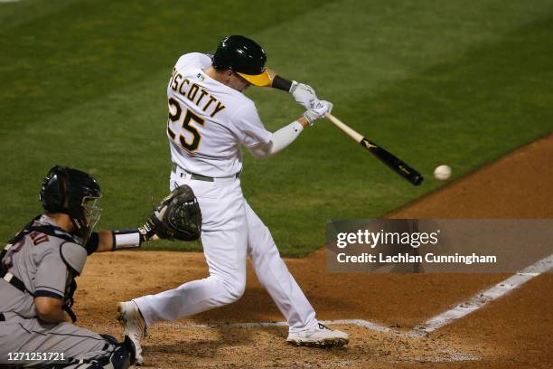 Stephen Piscotty of the Oakland Athletics hits an RBI single in the bottom of the eighth inning against the Houston Astros at Oakland-Alameda County...
