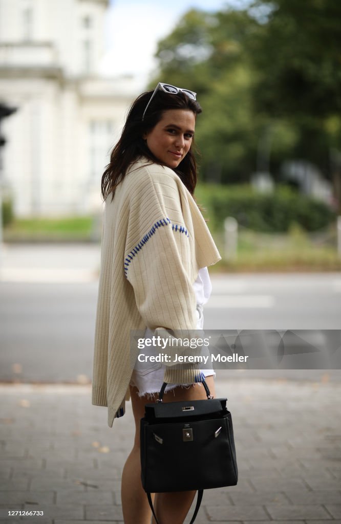 Lou Beyer wearing Hermes bag, Zara short and Ader Error cardigan on News  Photo - Getty Images