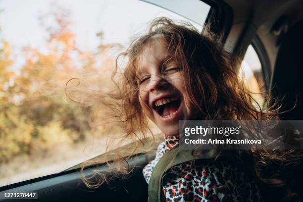 little girl sitting in the car - free tiny girls stock-fotos und bilder