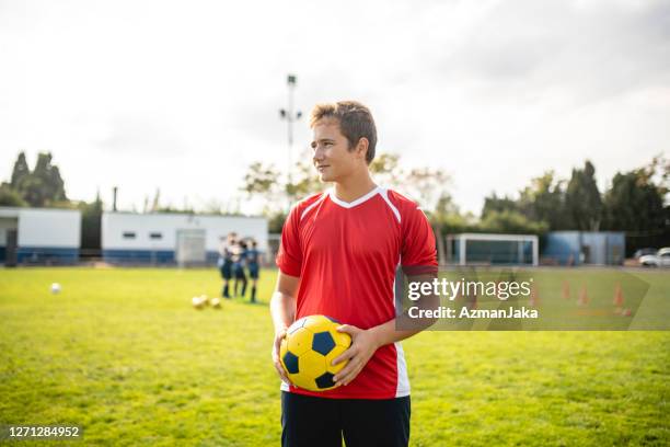 portrait of 16 year old male footballer on sports field - 16 year stock pictures, royalty-free photos & images