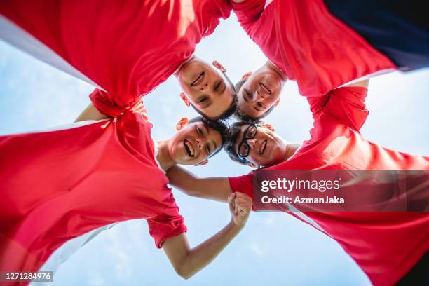 overhead portrait of smiling boy footballers - football huddle overhead stock pictures, royalty-free photos & images