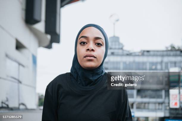 portrait of young sports woman with hijab in berlin - islam stock pictures, royalty-free photos & images