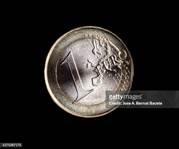 one euro coin on a black background. - 1 euro stock-fotos und bilder