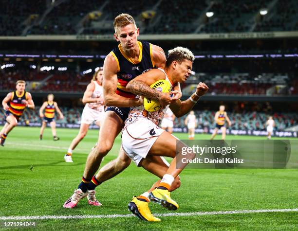 David Mackay of the Crows tackles Bobby Hill of the Giants during the round 16 AFL match between the Adelaide Crows and the Greater Western Sydney...