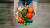 Whole Foods, Plant based diet ingredients in eco friendly zero waste packaging. Fresh raw food seasonal vegetables on home kitchen. Vegetarian, vegan food cooking ingredients