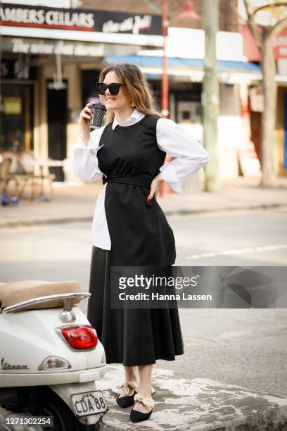 Designer Vanessa Moe wearing white shirt, VanessaMoe black top, Zara leather black skirt and The Row satin bow detailed mules on September 08, 2020...