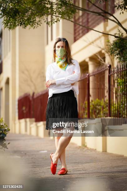 Designer Vanessa Moe wearing VanessaMoe scarf as a face mask and black fringe skirt, white shirt and red Hermes mules on September 08, 2020 in...