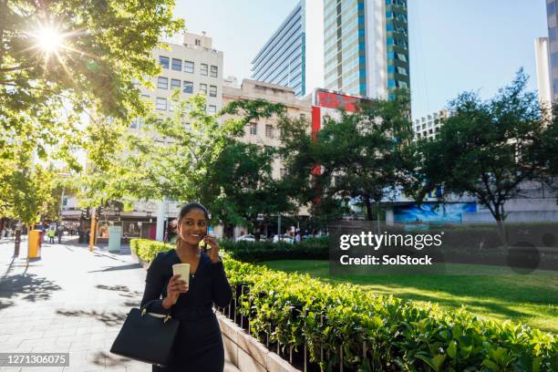 walking chatting with a coffee - perth cbd stock pictures, royalty-free photos & images