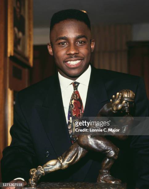 Desmond Howard of the University of Michigan Wolverines poses after being awarded the Heisman Trophy given to the top football player in the National...