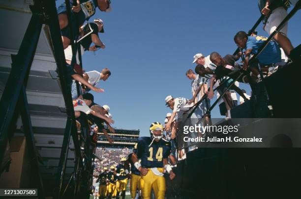 Fans reach out to Brian Griese Quarterback for the University of Michigan Wolverines as he walks down the tunnel after the NCAA Division I-A Big 10...