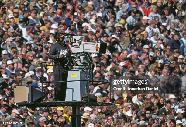 Canon Digi Super 70 television camera and operator during the NCAA Big Ten Conference college football game between the University of Michigan...