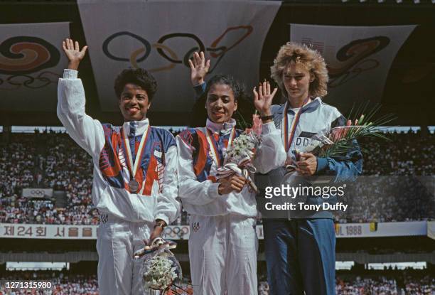 Florence Griffith-Joyner of the United States celebrates winning the gold medal in the Women's 100 metres final event with second placed silver...