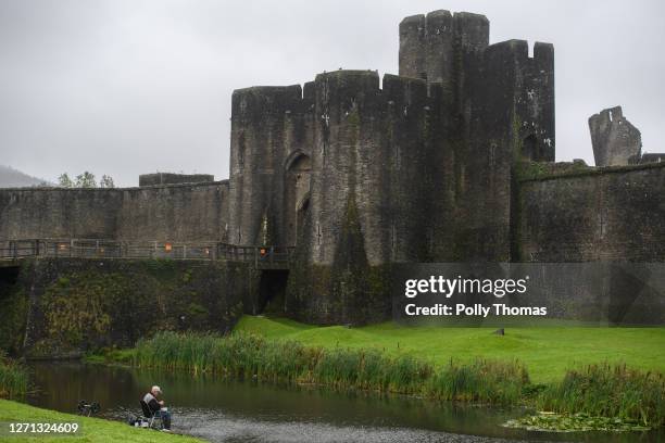 Man fishing in the Caerphilly Castle moat on September 08, 2020 in Caerphilly, United Kingdom. The county borough of Caerphilly in South Wales is to...