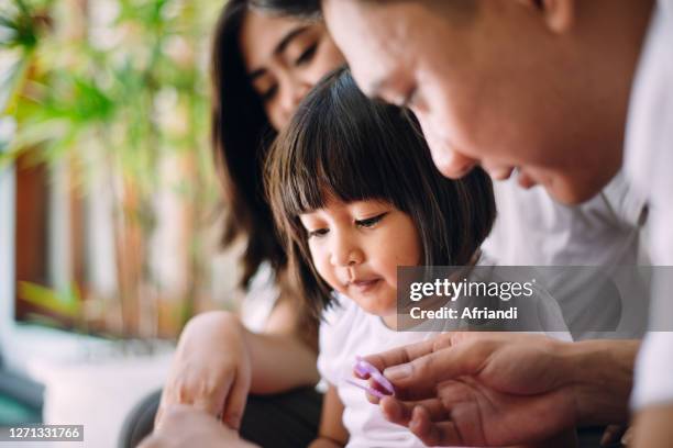 young family spending quality time together - indonesia family stock pictures, royalty-free photos & images