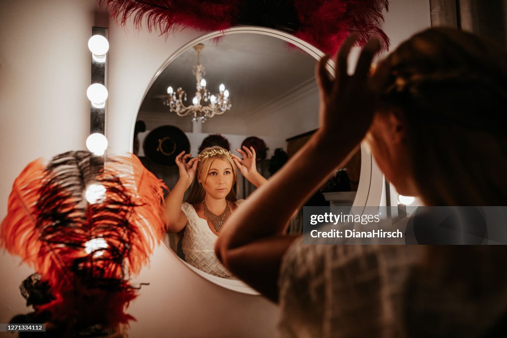 Theatre actress backstage in front of the mirrow