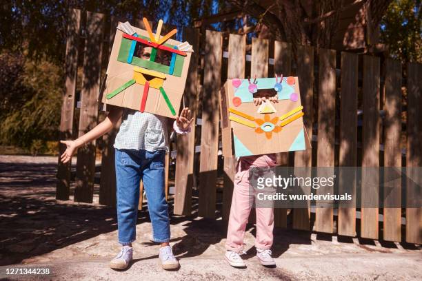 two little girls dressed as robots having fun in garden - costume players stock pictures, royalty-free photos & images