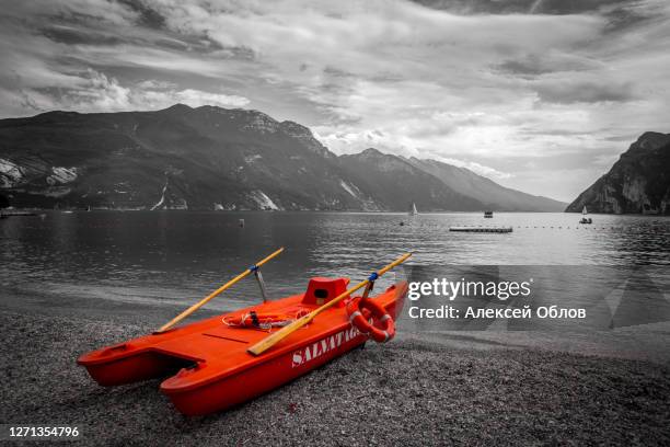 riva del garda, italy - july 02, 2014: rescue rowing catamaran. italian paddle boat for the rescue italian: salvataggio - salvataggio stock pictures, royalty-free photos & images