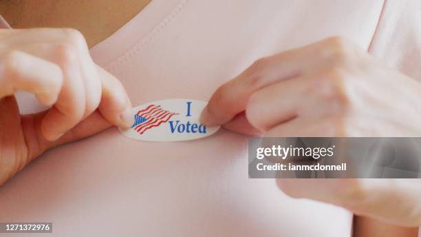 woman with i voted sticker - voting sticker stock pictures, royalty-free photos & images