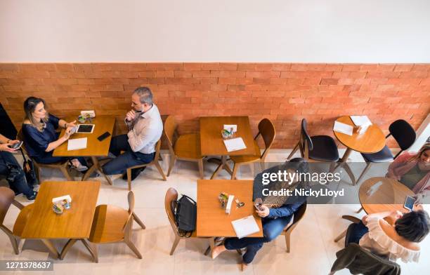 people in a cafe - seat 600 stock pictures, royalty-free photos & images