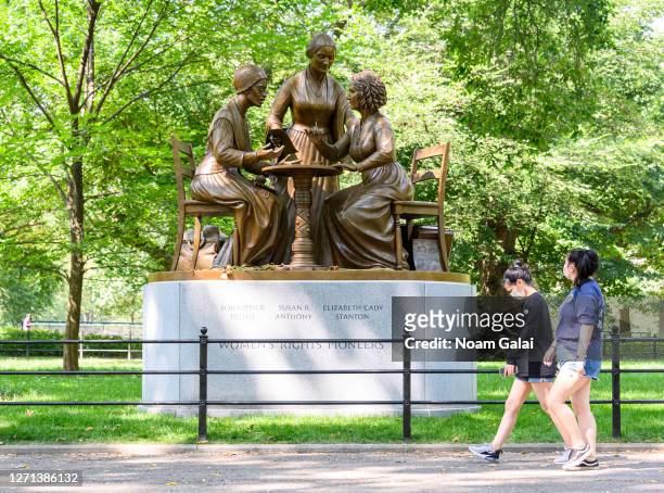 People visit the Women’s Rights Pioneers monument honoring Susan B. Anthony, Sojourner Truth and Elizabeth Cady Stanton in Central Park as the city...