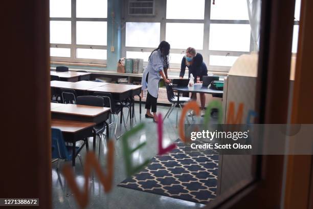 Jasmine Gilliam and Lucy Baldwin, teachers at King Elementary School, prepare to teach their students remotely in empty classrooms during the first...