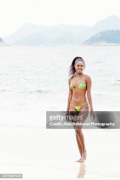 athletic black woman in her thirties wearing a bikini on the beach - beautiful black women in bathing suits stock pictures, royalty-free photos & images