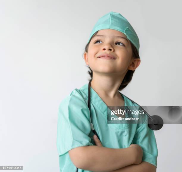 portrait of a thoughtful boy dressed up as a doctor - máscara-vestir-se imagens e fotografias de stock