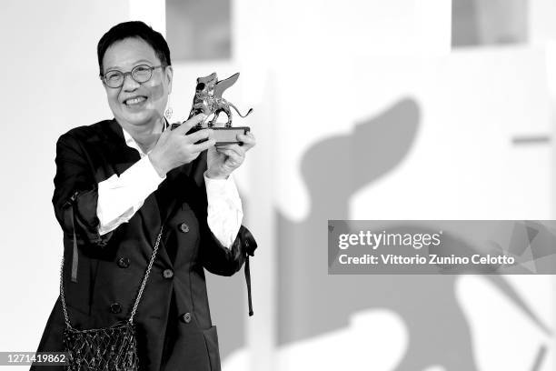 This image has been converted to black and white. Director Ann Hui poses on the red carpet with the Golden Lion Lifetime achievement award after the...