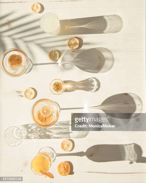 flat lay of glasses and cups in harsh light - champagne stock pictures, royalty-free photos & images