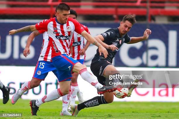 Ventura Alvarado of San Luis fights for the ball with Ian Gonzalez of Necaxa during the 9th round match between Atletico San Luis and Necaxa as part...