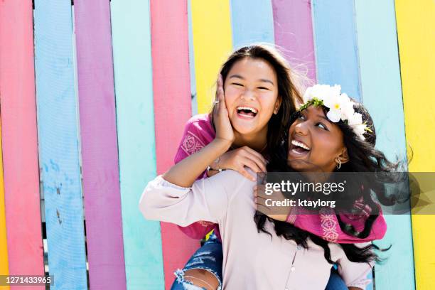 best friends show the sheer joy of spending time together - colorful background stock pictures, royalty-free photos & images