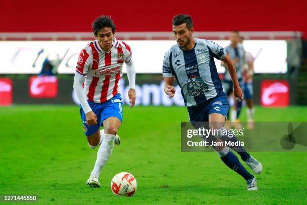 Jose Juan Macias of Chivas fights for the ball with Gustavo Cabral of Queretaro during the 9th round match between Chivas and Queretaro as part of...