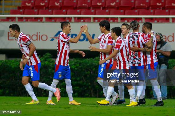 Jose Juan Macias of Chivas celebrates with teammates after scoring the first goal of his team during the 9th round match between Chivas and Queretaro...