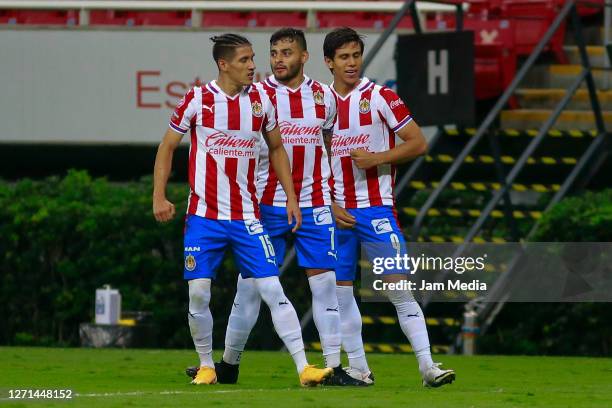 Jose Juan Macias of Chivas celebrates with Carlos Uriel Antuna and Alexis Vega after scoring the first goal of his team during the 9th round match...