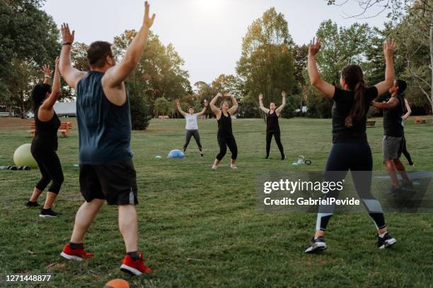 people doing functional training in the park - natural parkland stock pictures, royalty-free photos & images