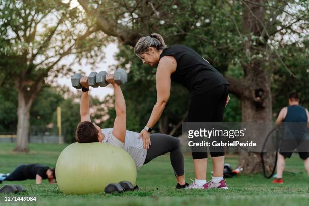 people doing functional training in the park - running coach stock pictures, royalty-free photos & images