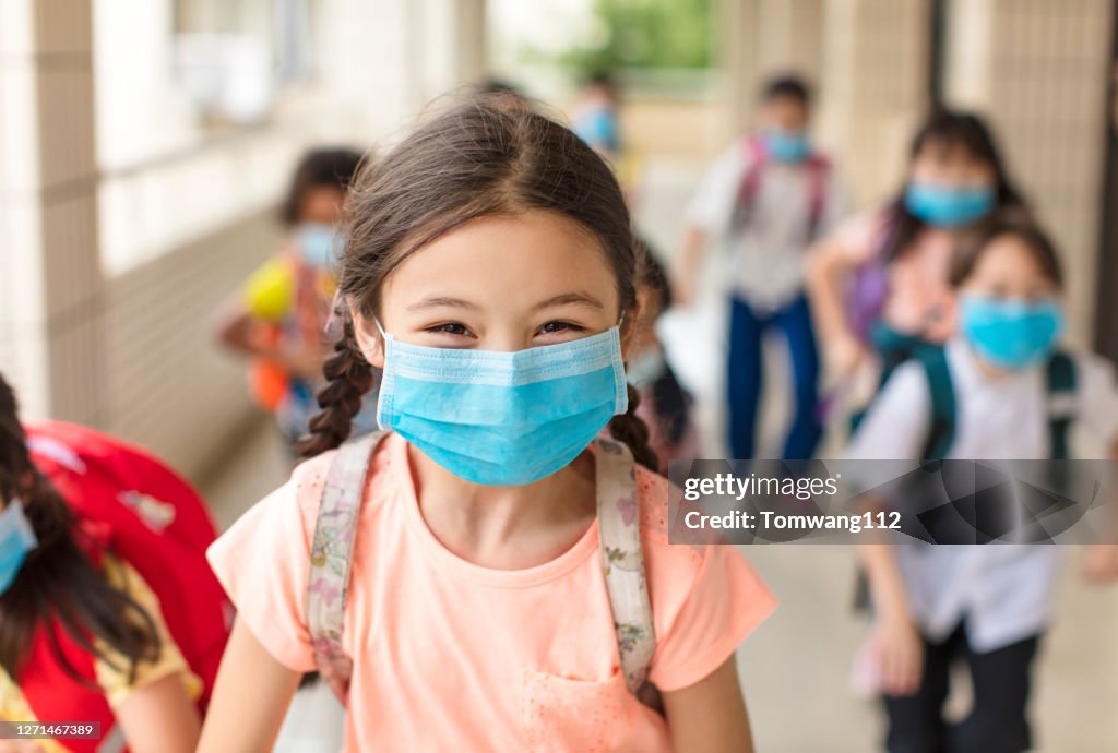 Children wearing  face medical mask back to school after covid-19 quarantine