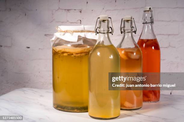 kombucha infused with strawberries, pineapple, lemon and ginger - suor stock pictures, royalty-free photos & images